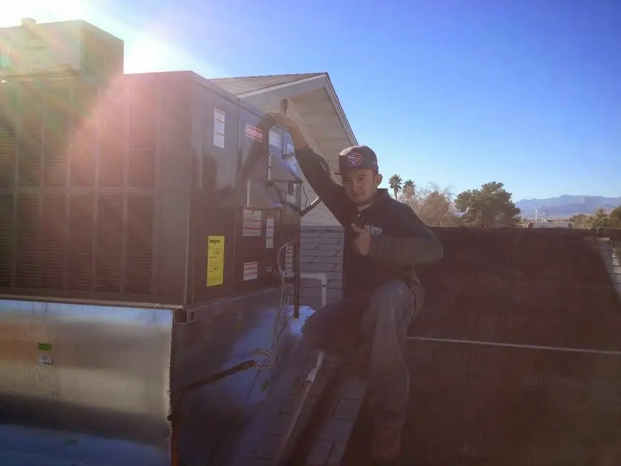 HVAC technician performing HVAC Inspection on a rooftop unit in Minnetrista
